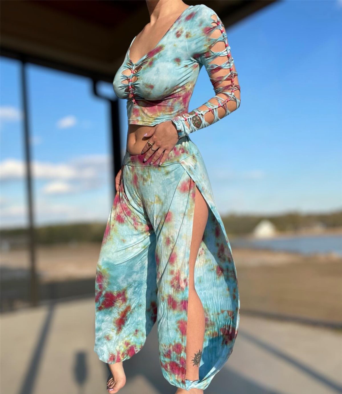 A person wearing a blue and pink tie-dye two-piece crop top and skirt set.