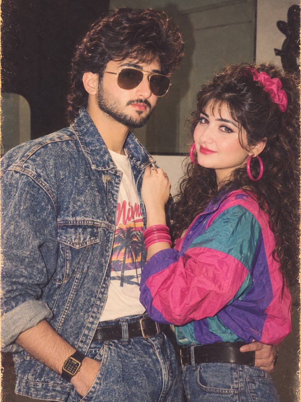 A man in a denim jacket and a woman in a colorful windbreaker posing together.