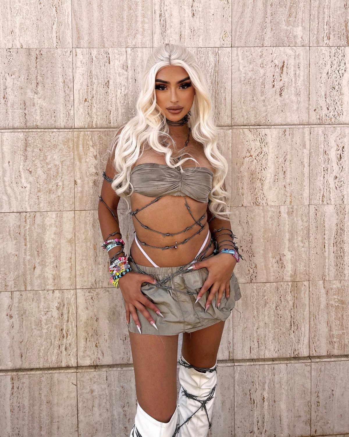 Blonde woman posing in a sage green matching crop top and shorts set.