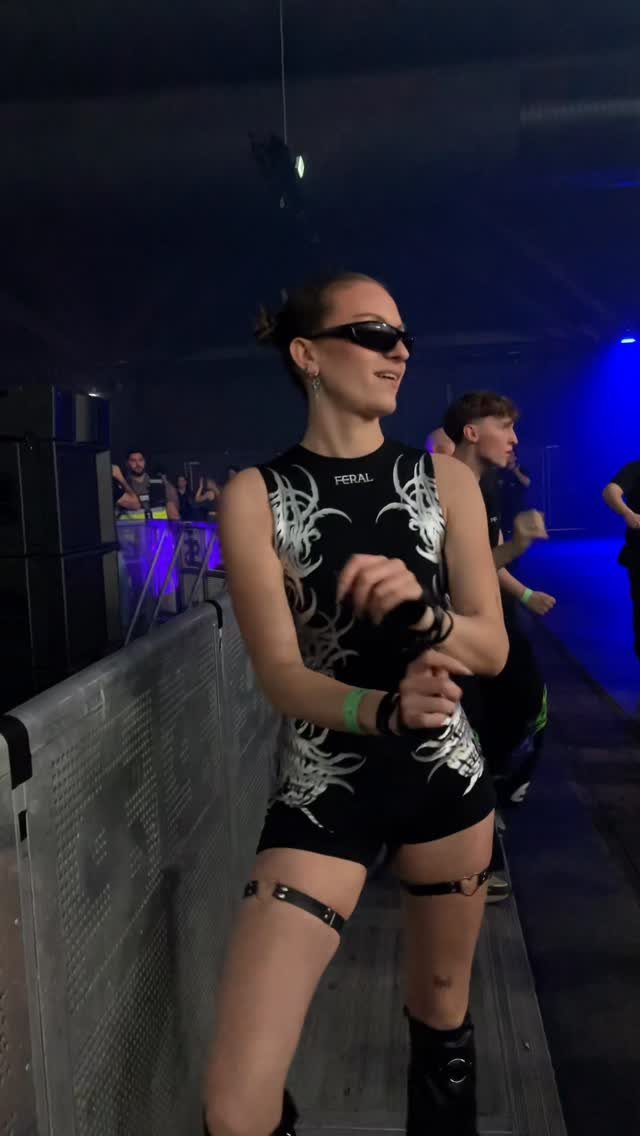 Woman wearing a black and white tribal pattern romper and sunglasses at a club.