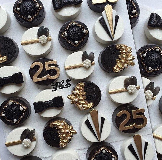 Decorated black and white Art Deco themed cookies with gold accents and pearls.