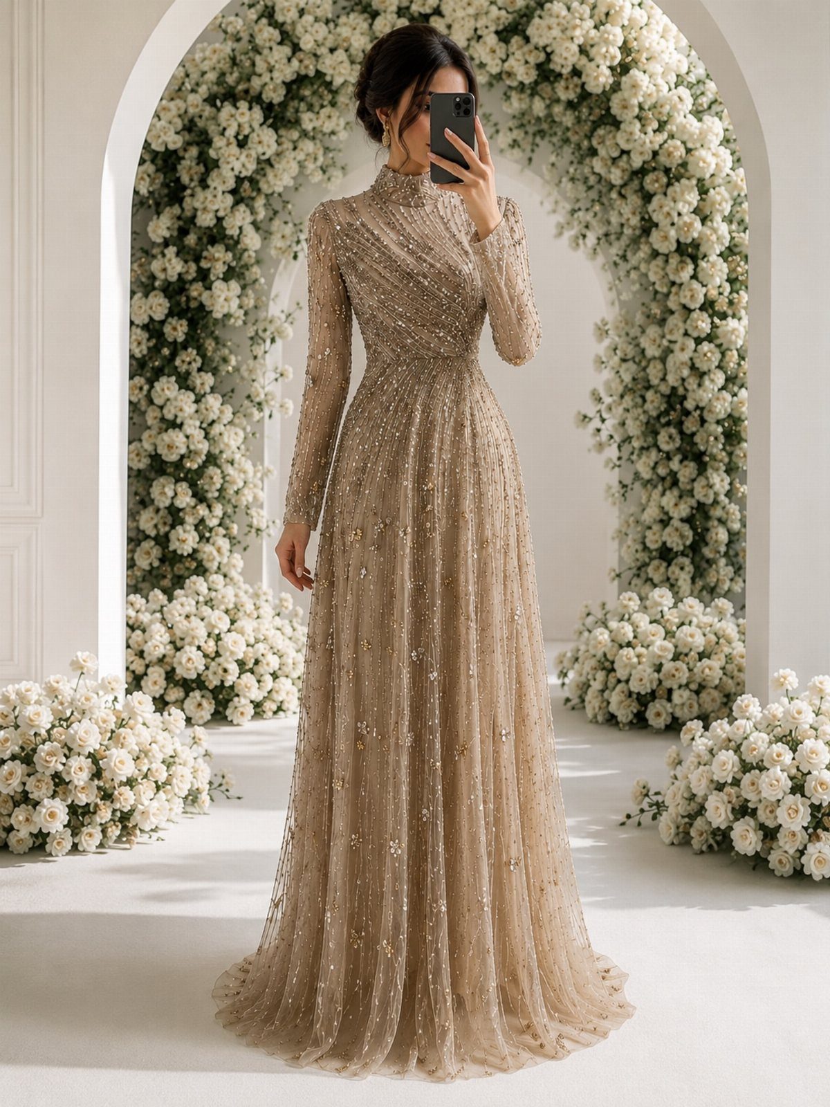 Woman wearing a shimmering champagne sequined gown standing in front of a white flower arch.