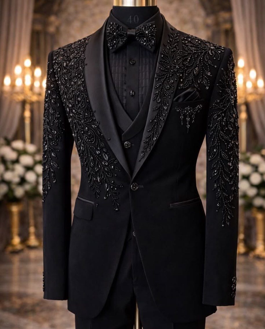 Black velvet tuxedo jacket with intricate black beadwork displayed on a mannequin.