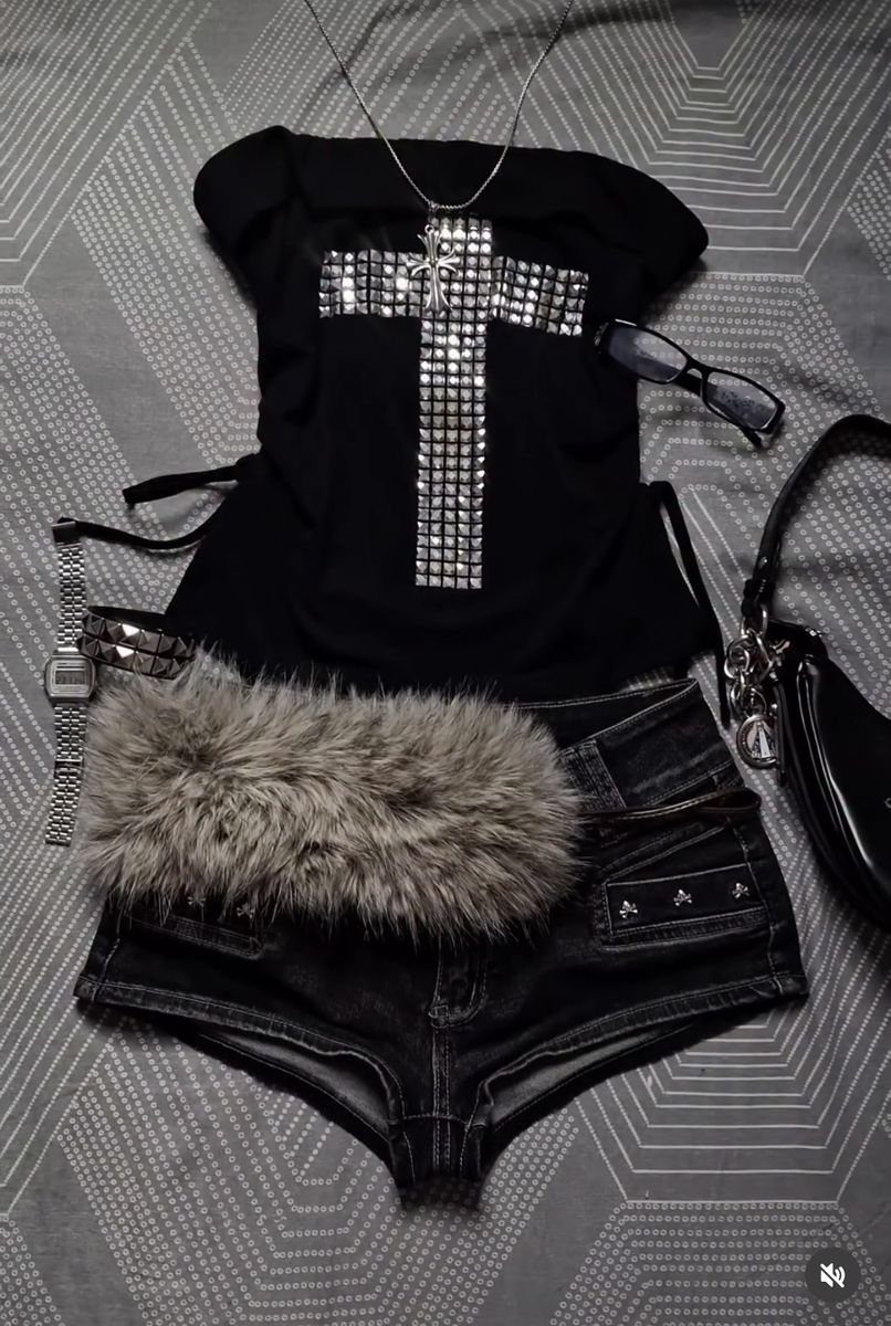 Black tank top with a large rhinestone cross and denim shorts with faux fur trim.
