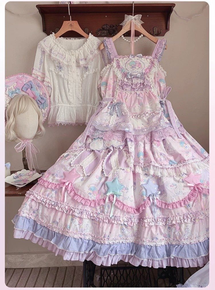 Pink and lavender ruffled Lolita dress, a white lace blouse, and a matching hat hanging on a wall.