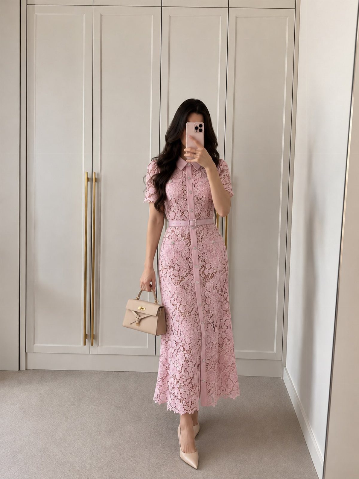 Woman in a mauve lace A-line midi dress posing for a mirror selfie.