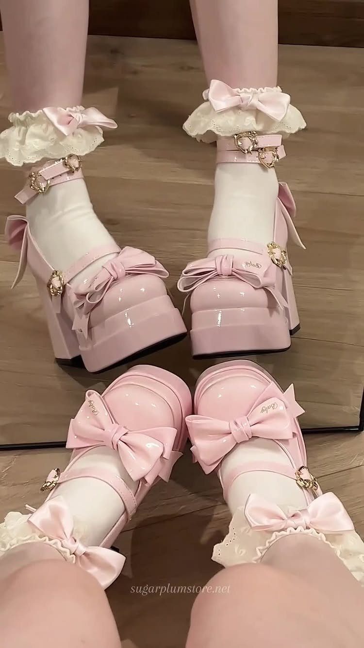 Pink platform Mary Jane shoes with large bows worn with ruffled white socks and pink tights.
