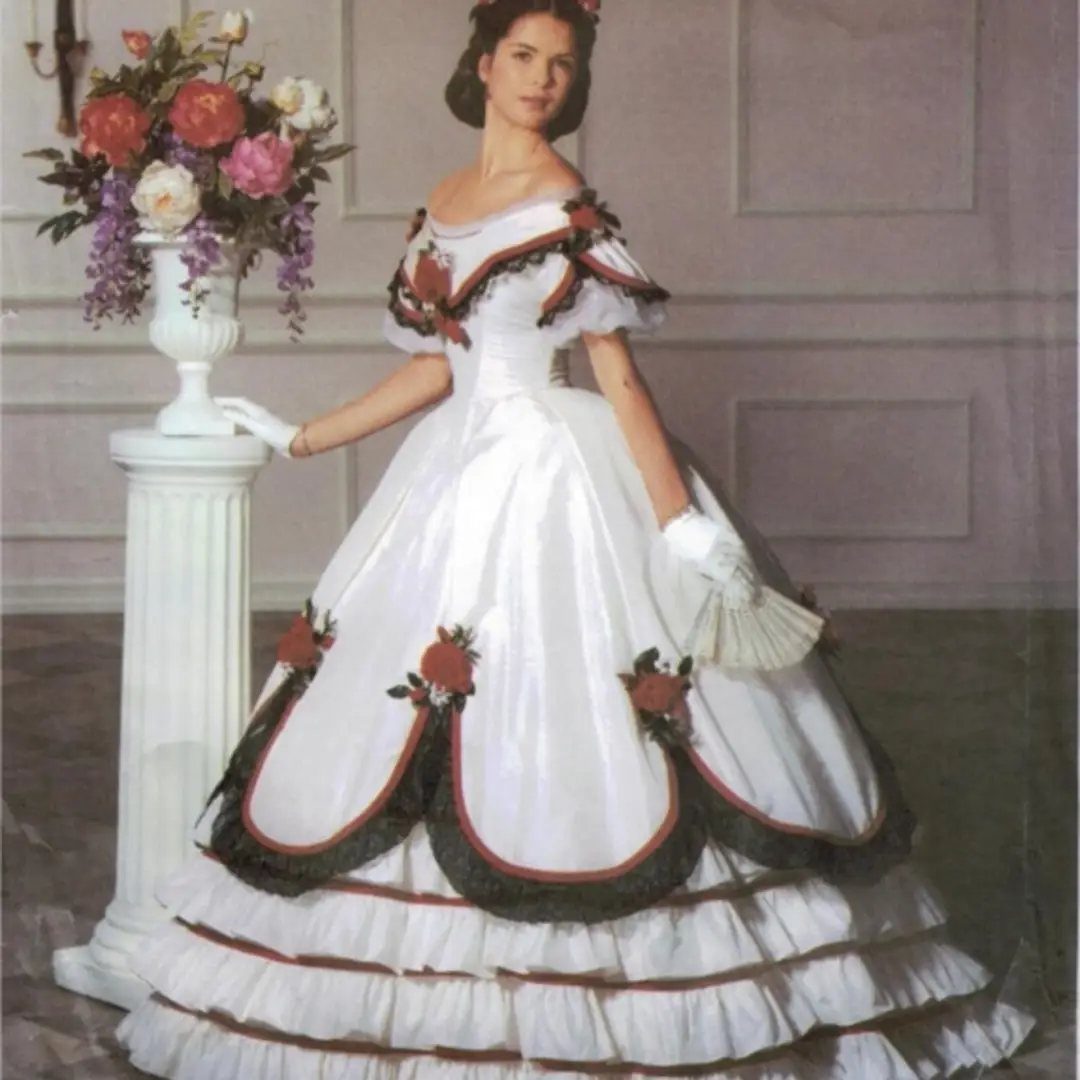 A woman in a white Victorian ball gown with dark ruffles and red floral details.